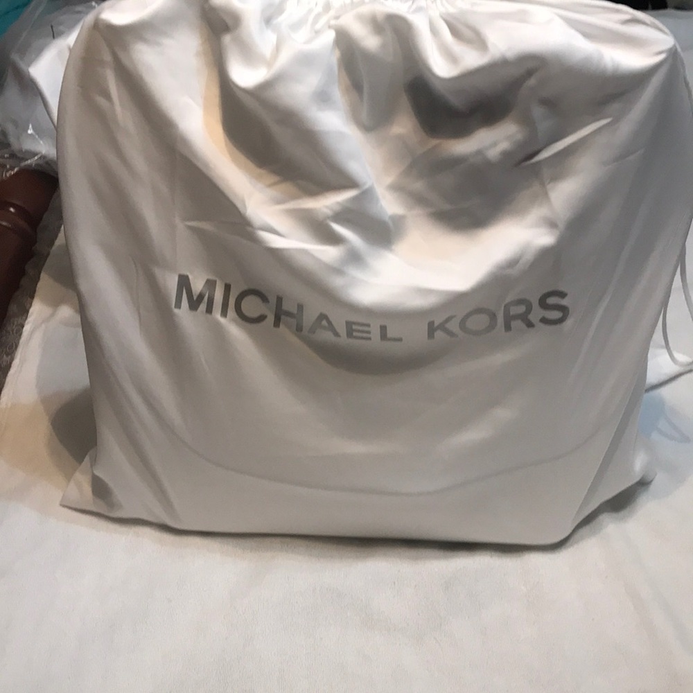 White Michael Kors purse with purse scarf.